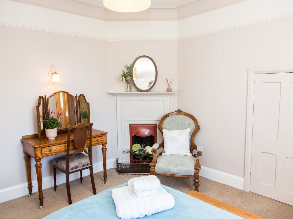 A bedroom with a vanity table and a chair at Whitebeams Pett Bottom near Stelling Minnis