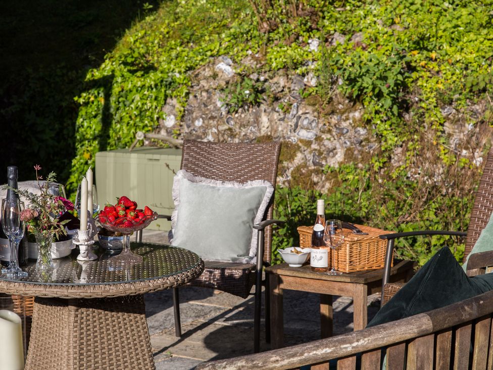 An outdoor area with a table and chairs at Whitebeams Pett Bottom near Stelling Minnis