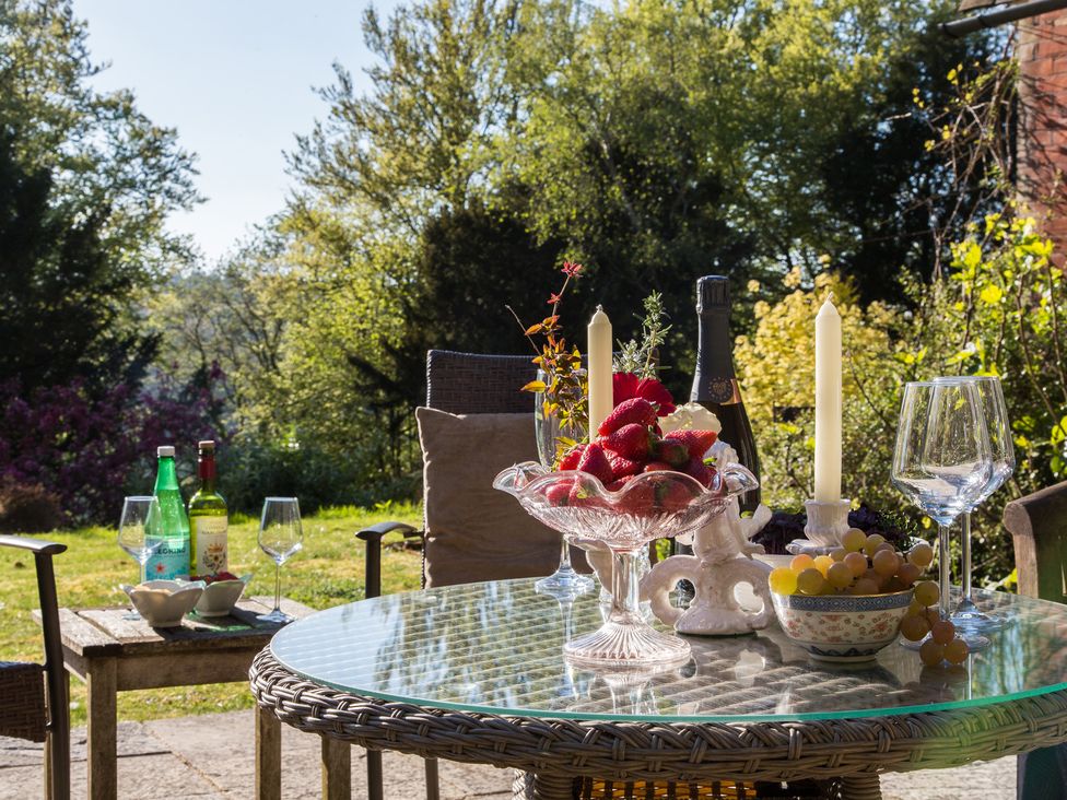 A table set with fruit and drinks outdoors at Whitebeams Pett Bottom near Stelling Minnis