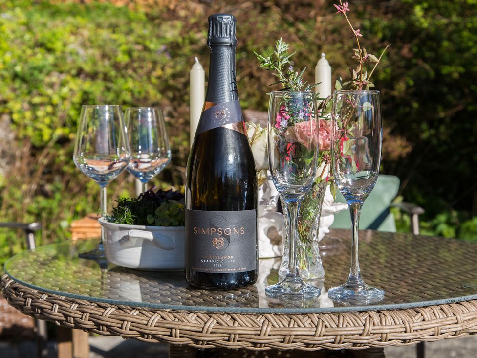 A table with champagne and wine glasses in a garden at Whitebeams Pett Bottom near Stelling Minnis