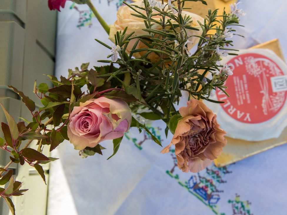 A bouquet of flowers and cheese on a table at Whitebeams in Pett Bottom near Stelling Minnis