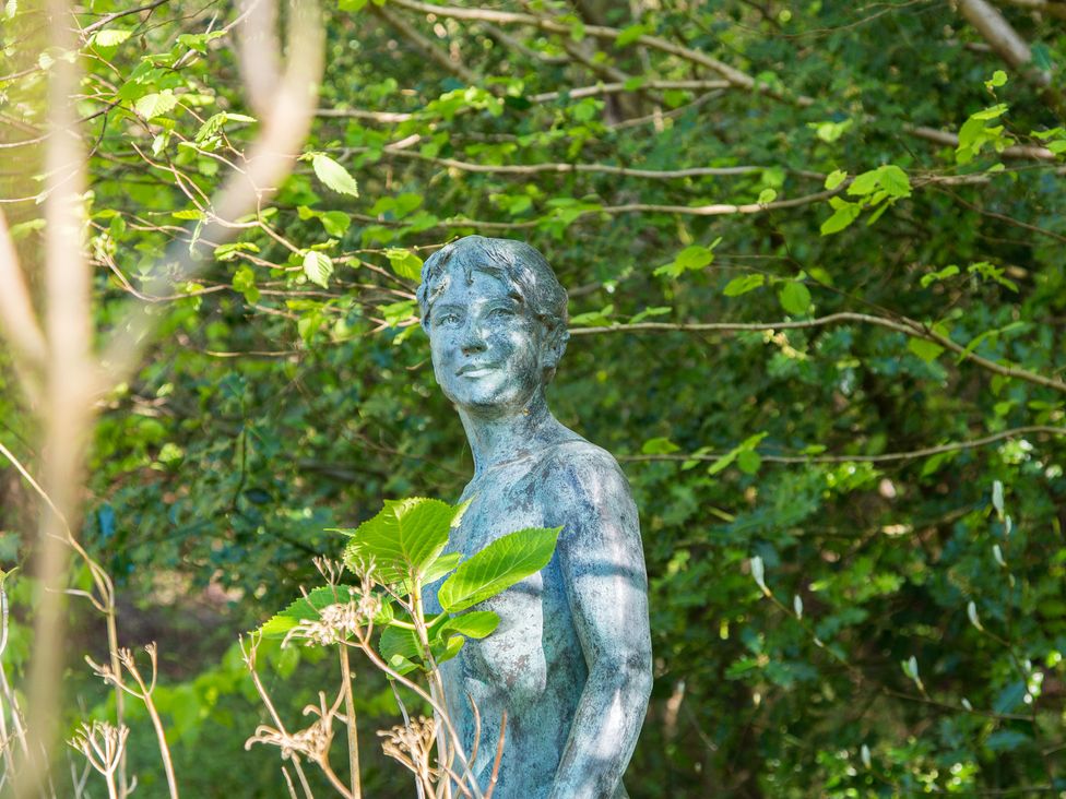A statue surrounded by greenery at Whitebeams in Pett Bottom near Stelling Minnis