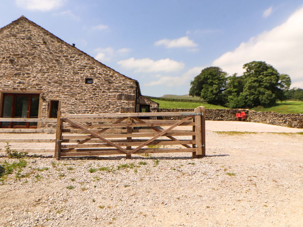 An outdoor area with a stone barn and wooden gate at Dam House Barn Lancaster