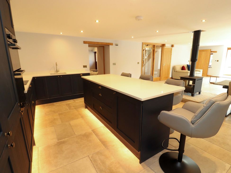 A kitchen with a central island and sink at Dam House Barn in Lancaster