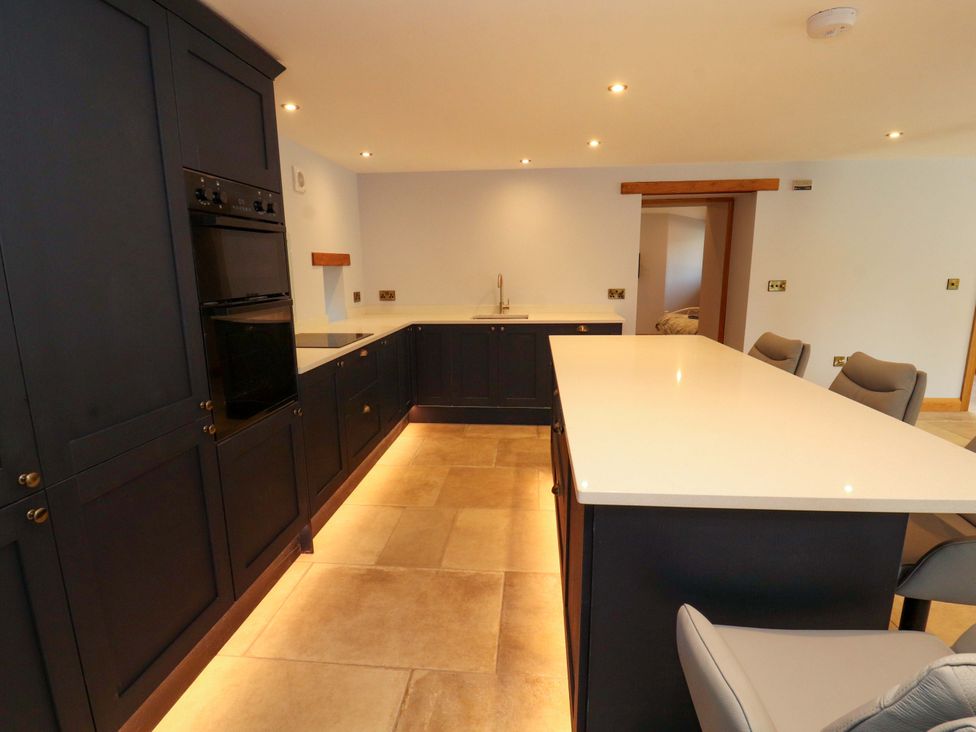 A kitchen with an island and appliances at Dam House Barn in Lancaster