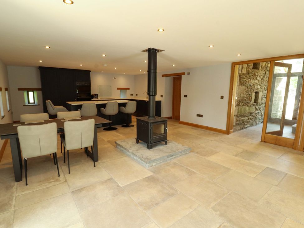A kitchen with a stove and dining area at Dam House Barn in Lancaster
