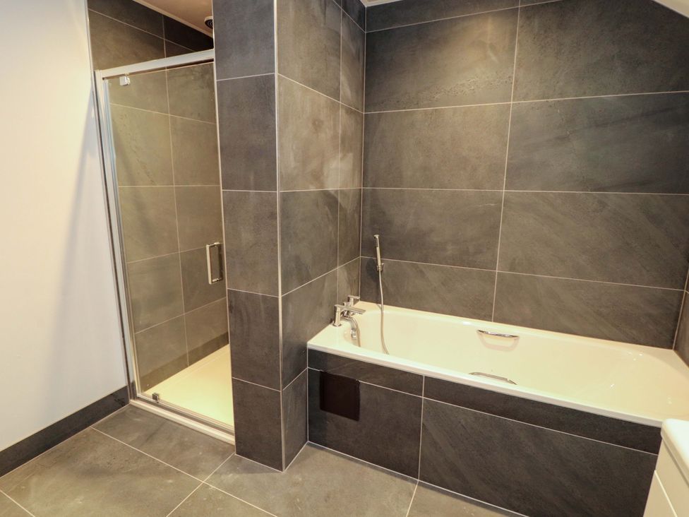 A bathroom with a shower and bathtub at Dam House Barn in Lancaster