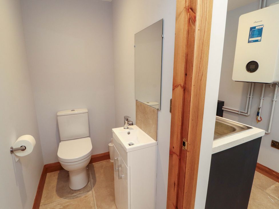 A bathroom with a toilet and sink at Dam House Barn Lancaster