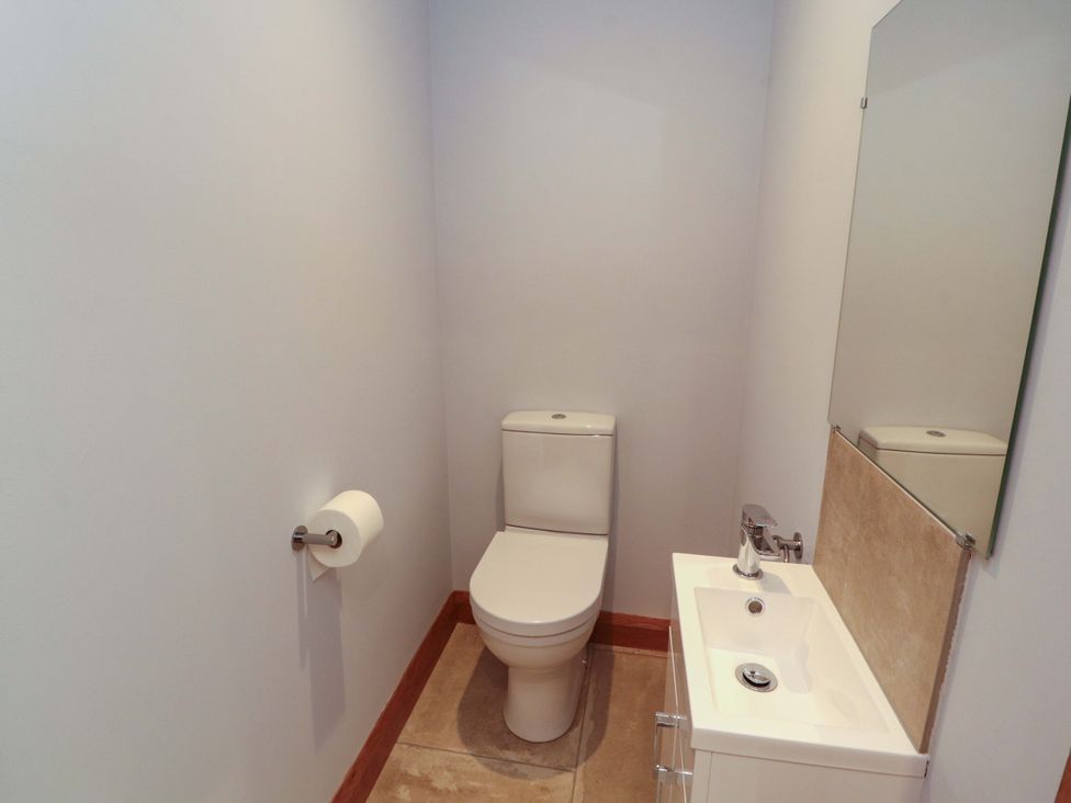 A bathroom with a toilet and sink at Dam House Barn in Lancaster