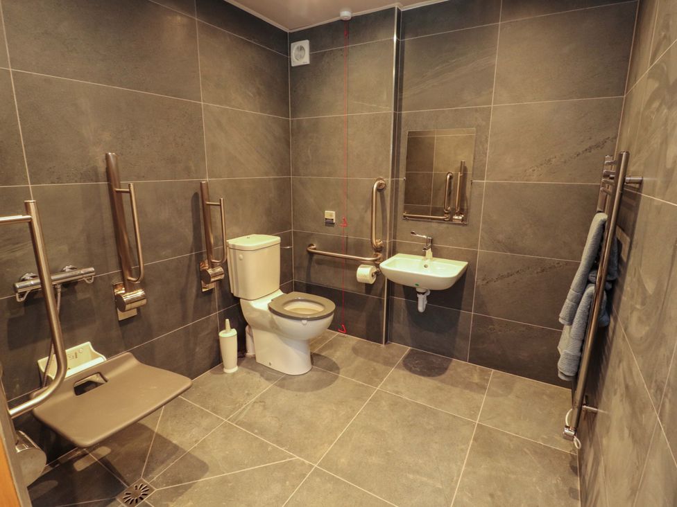 A bathroom with a toilet and sink at Dam House Barn in Lancaster