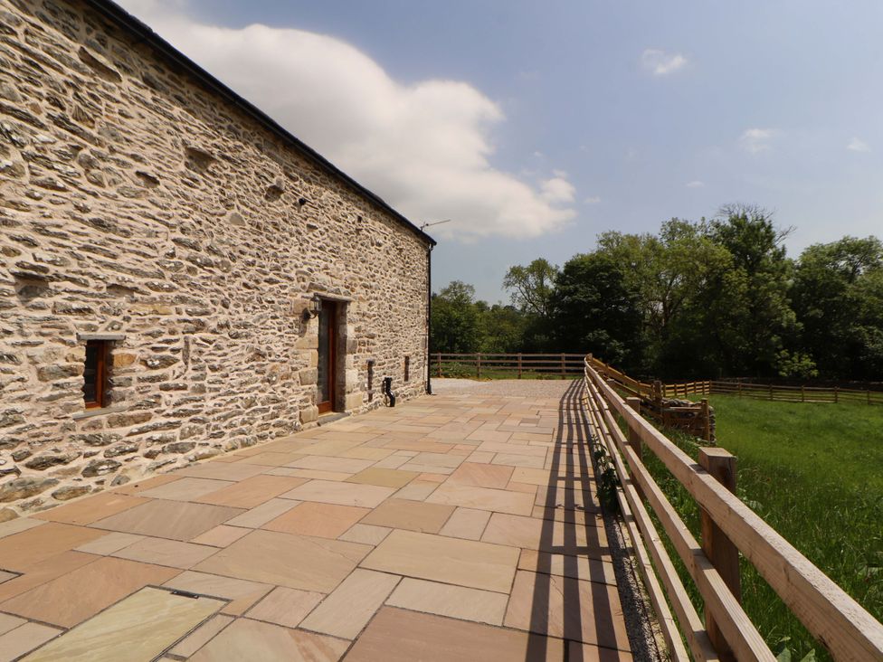 An outdoor area with a stone wall and pathway at Dam House Barn Lancaster