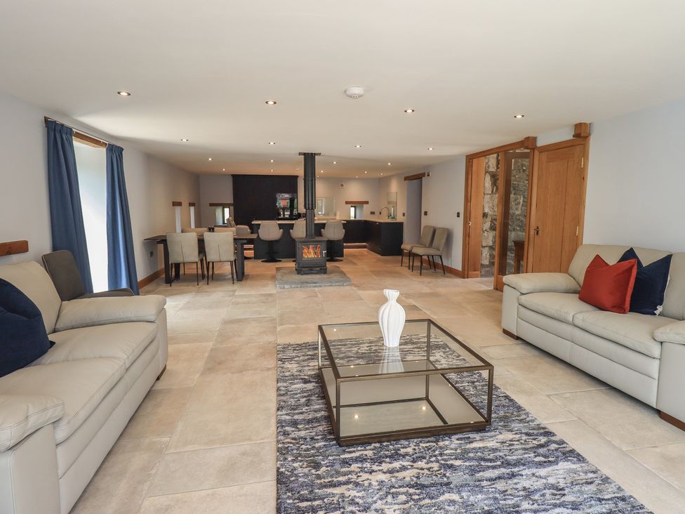 A living room with a coffee table and seating area at Dam House Barn Austwick