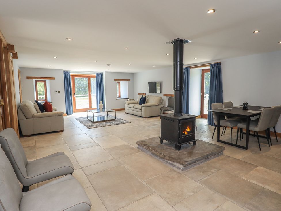 A living room with sofas and a fireplace at Dam House Barn in Austwick