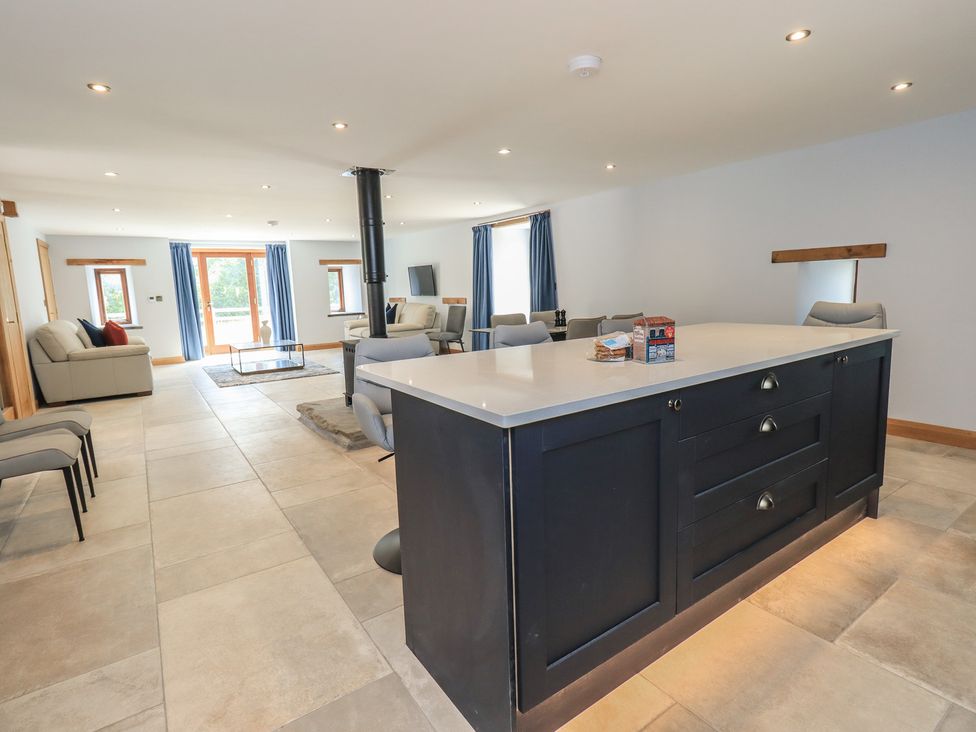 A living room with a kitchen island and sofa at Dam House Barn in Austwick