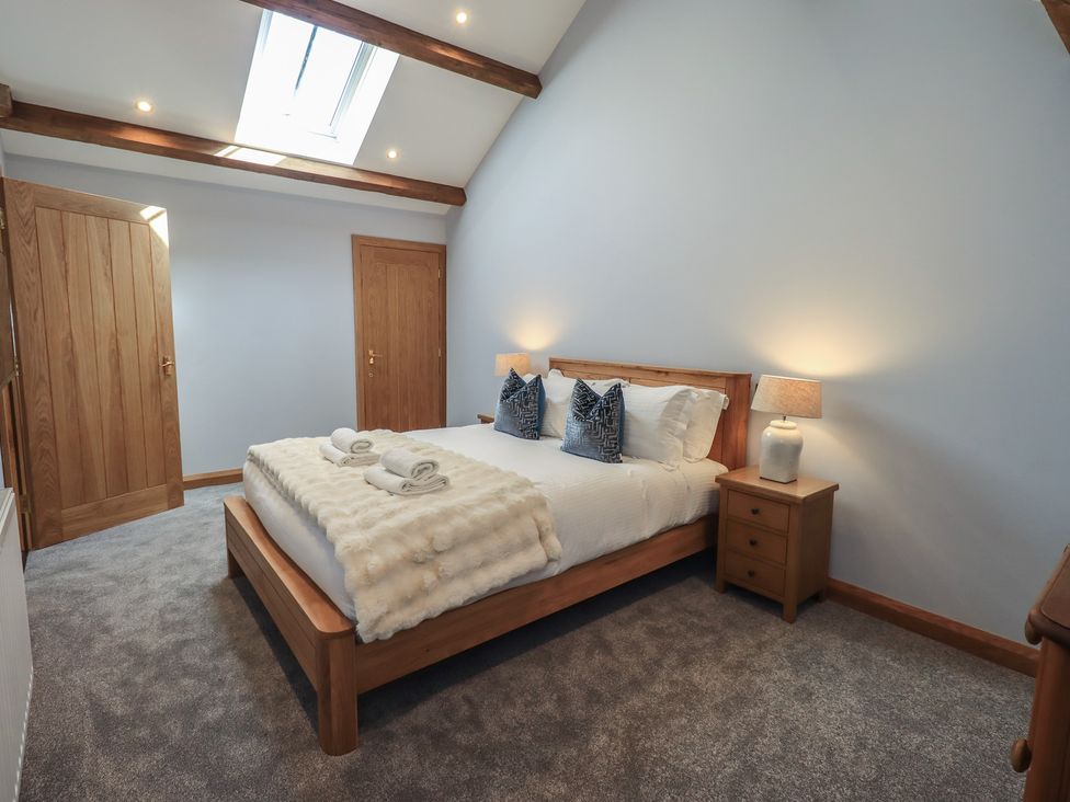 A bedroom with a bed and bedside table at Dam House Barn in Austwick