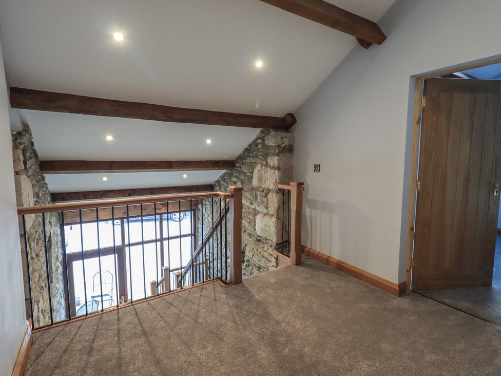 A landing area with stairs and railing at Dam House Barn in Austwick