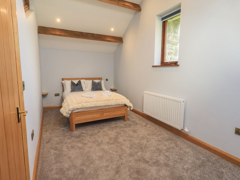 A bedroom with a bed and a window at Dam House Barn Austwick
