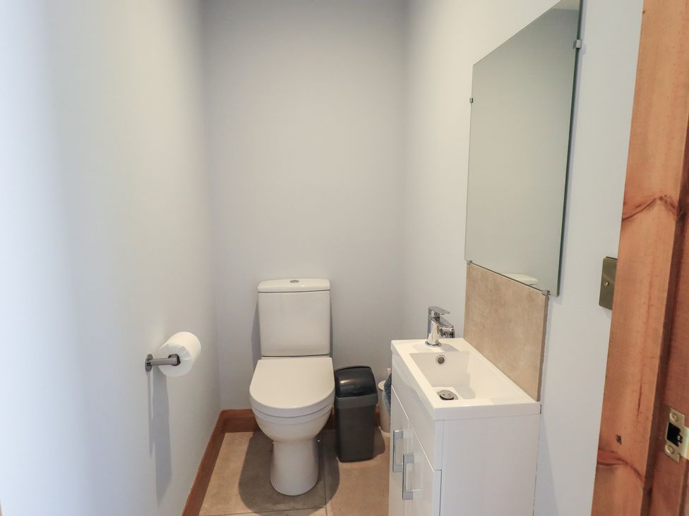 A bathroom with a toilet and sink at Dam House Barn in Austwick