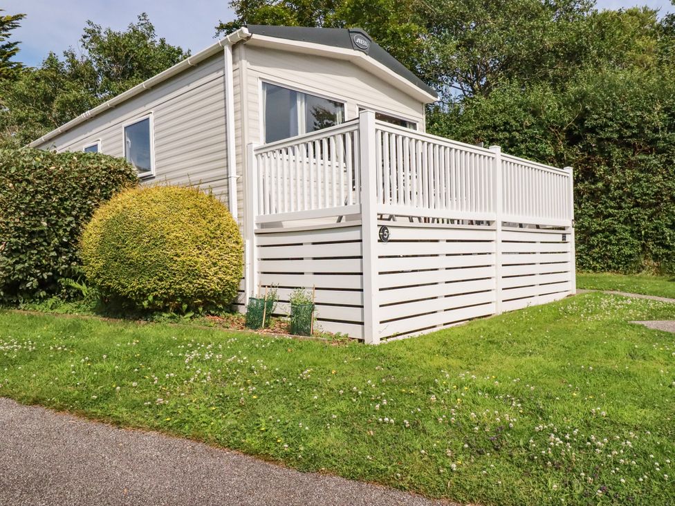 A mobile home with a deck and garden at 5 Silverbow