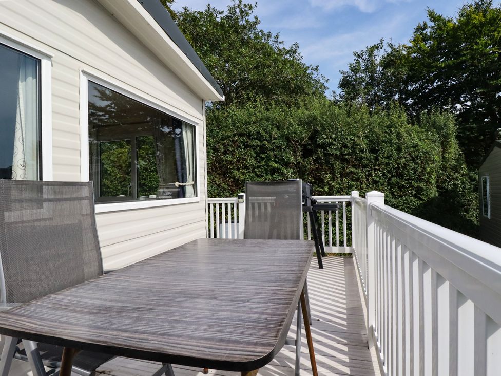 A deck with a table and chairs at 5 Silverbow