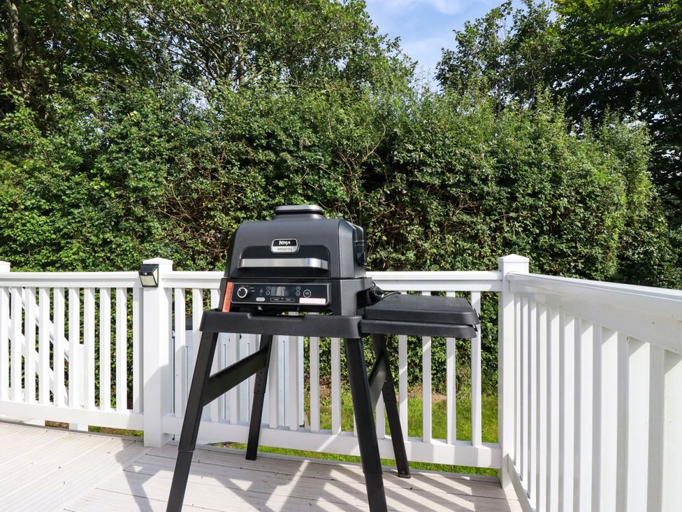 A grill on a deck with greenery in the background at 5 Silverbow
