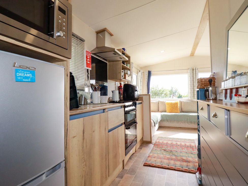 A kitchen with appliances and a seating area at 5 Silverbow