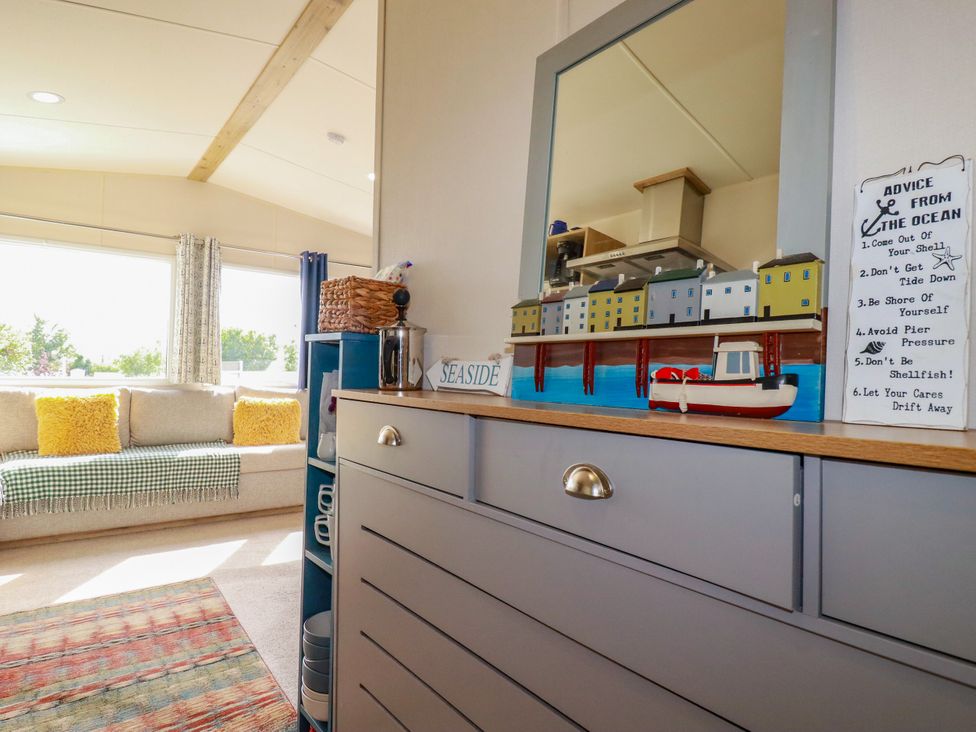 A living room with a sofa, cushions and decorative items at 5 Silverbow 
