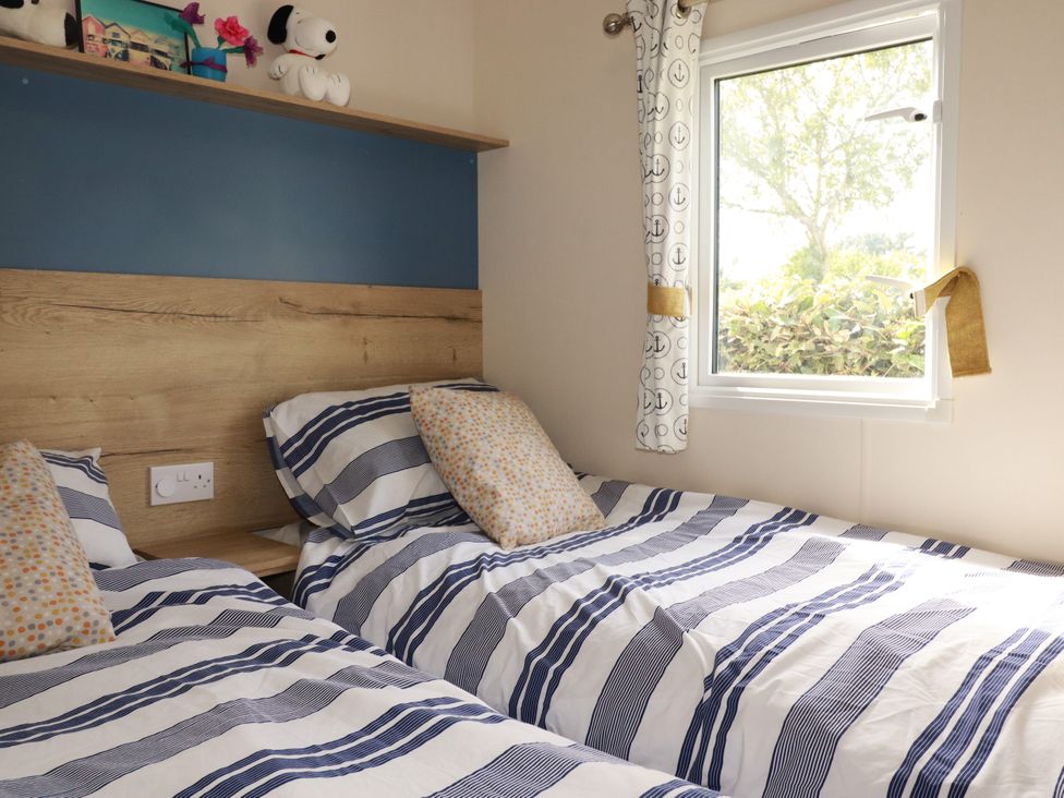 A bedroom with two beds and a window at 5 Silverbow