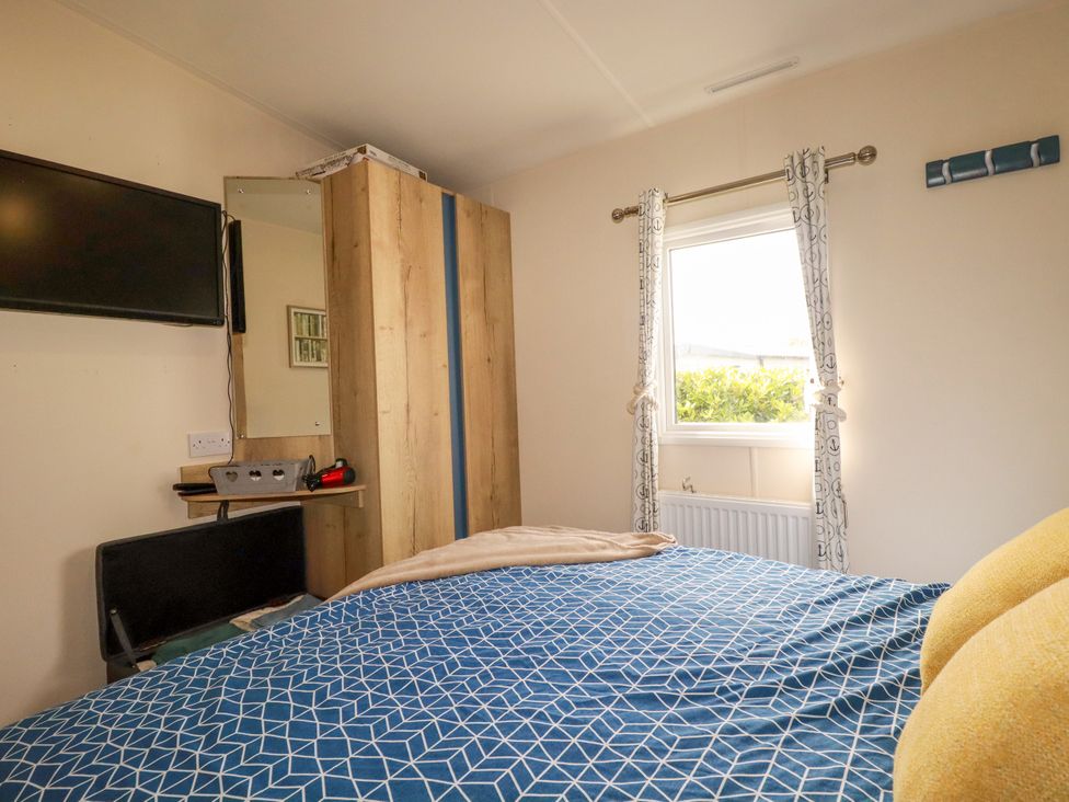 A bedroom with a bed and a wardrobe at 5 Silverbow