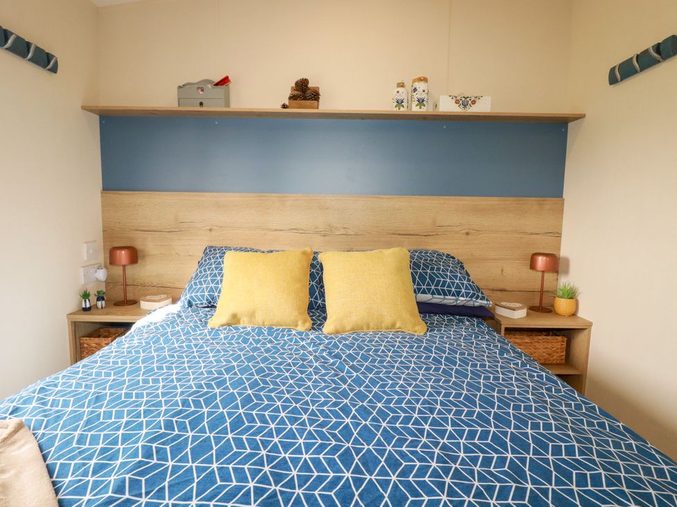 A bedroom with a bed and shelf at 5 Silverbow
