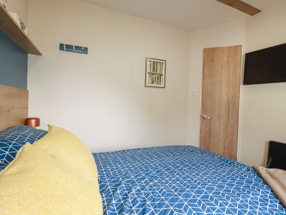 A bedroom with a bed and a door at 5 Silverbow