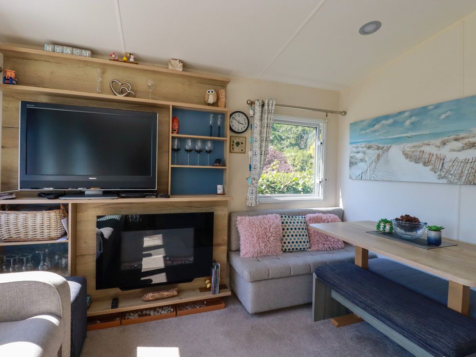 A living room with a television and sofa at Porthcurno 5 Perranwell near Goonhavern