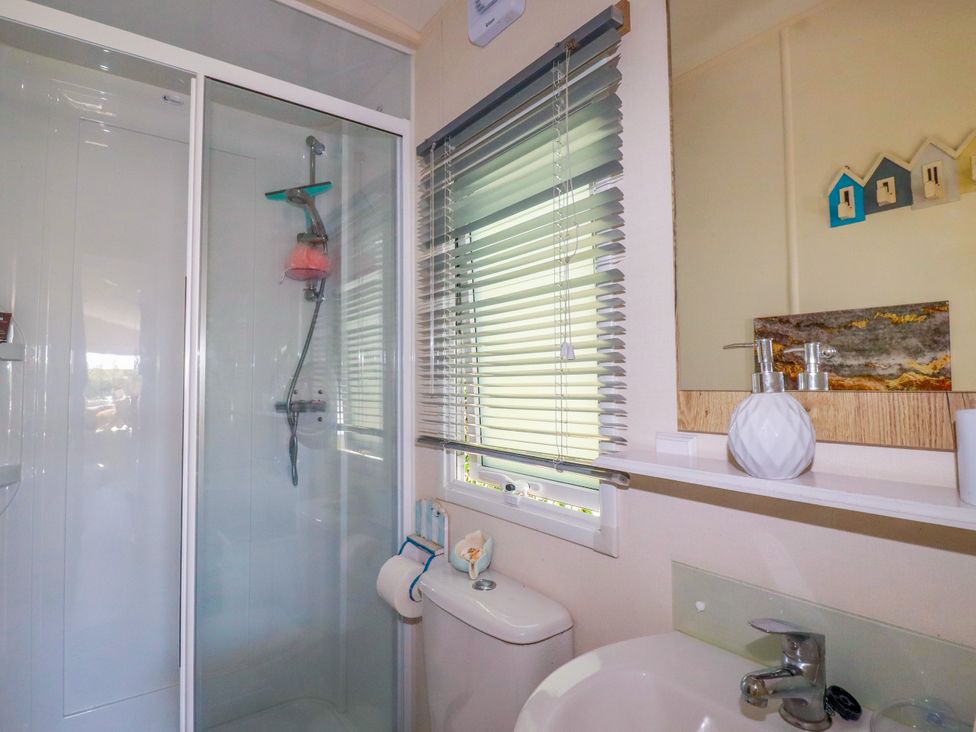A bathroom with shower, toilet, and sink at Porthcurno 5 Perranwell near Goonhavern