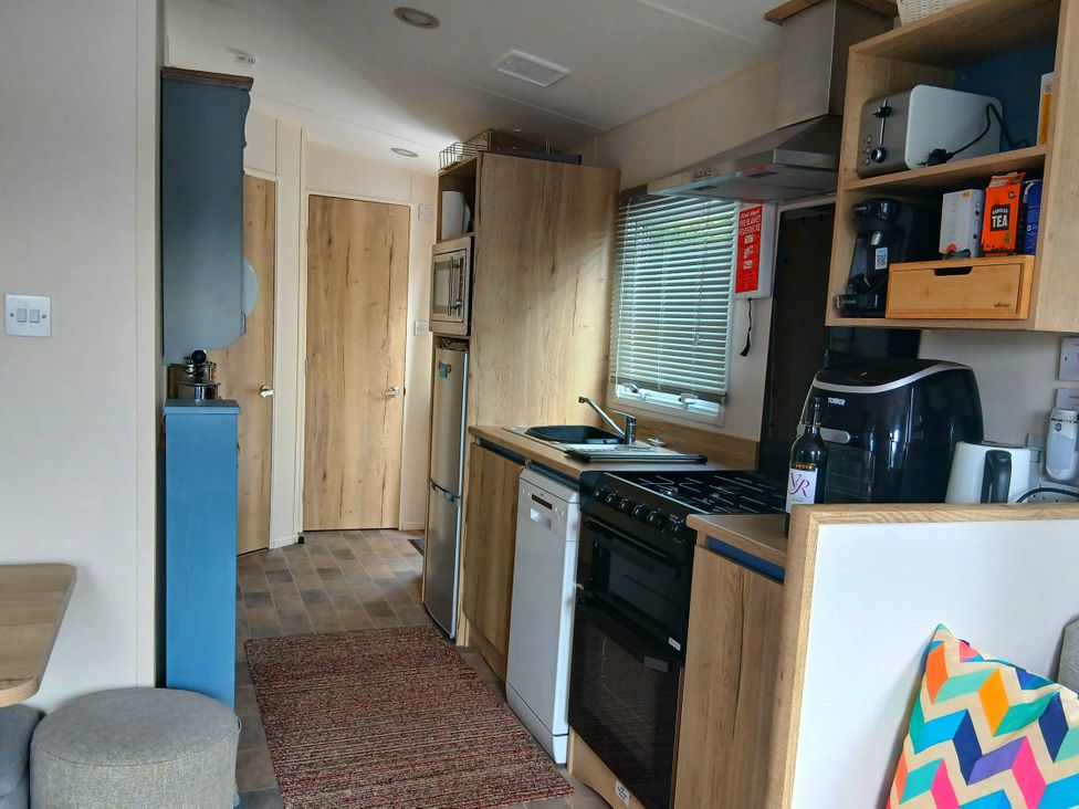A kitchen with appliances and storage in Porthcurno 5 Perranwell near Goonhavern