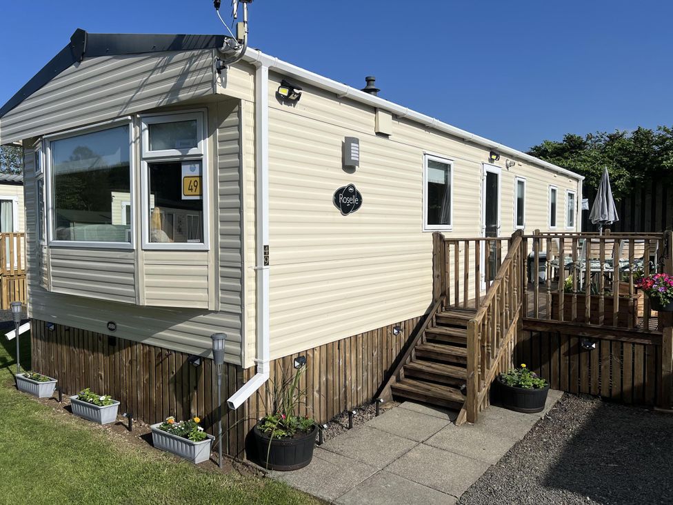 A caravan with steps and planters at Hornshole Hideaway Caravan Hawick Riverside Caravan Park near Hawick