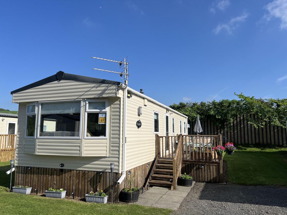 A caravan with steps and plants at Hornshole Hideaway Caravan Hawick Riverside Caravan Park near Hawick