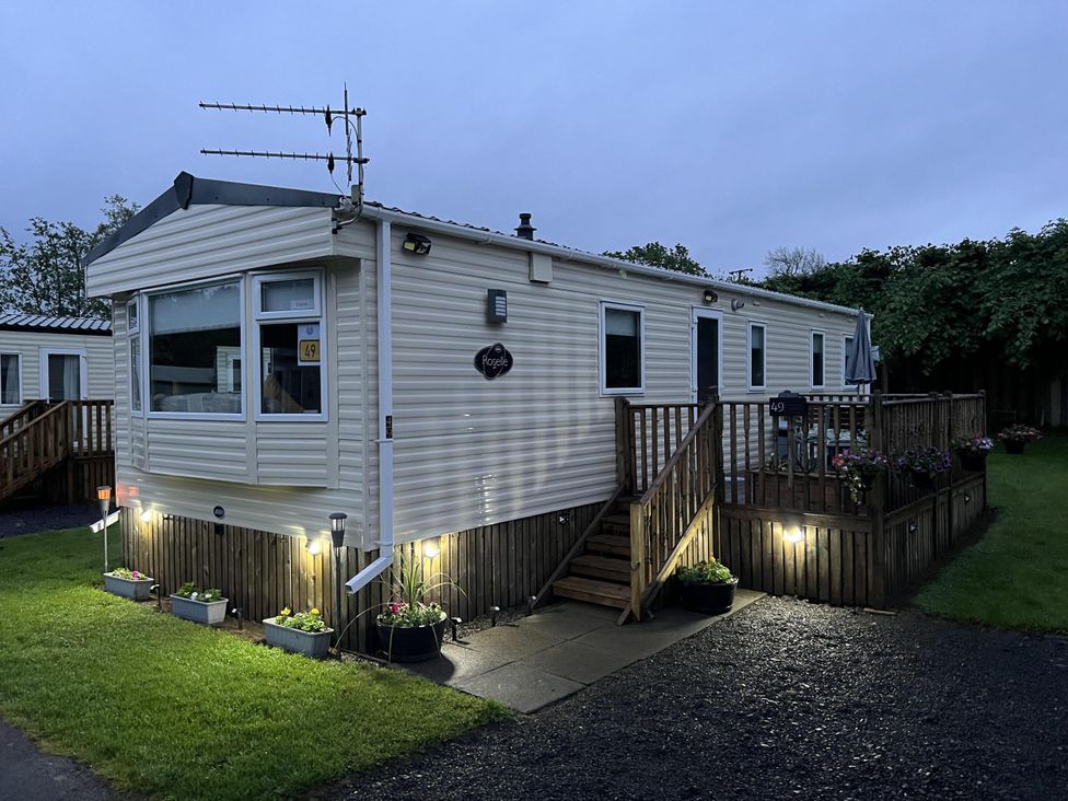 A caravan with decking and outdoor lights at Hornshole Hideaway Caravan Hawick Riverside Caravan Park near Hawick