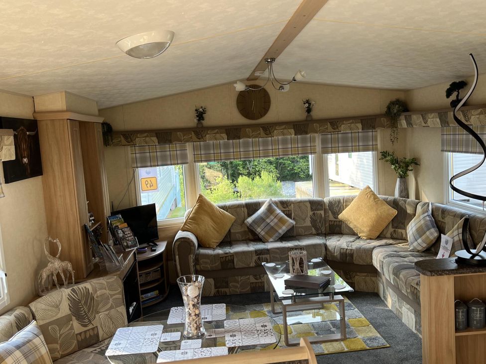 A living room with a sofa and coffee table at Hornshole Hideaway Caravan Hawick