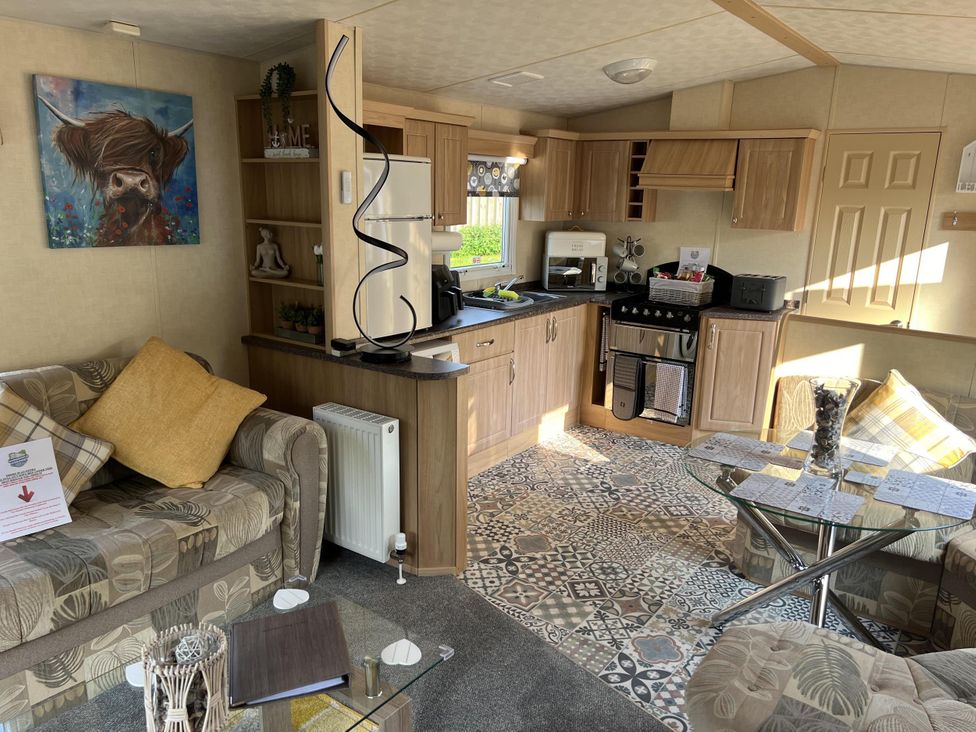 A living room with a kitchen area at Hornshole Hideaway Caravan Hawick Riverside Caravan Park near Hawick