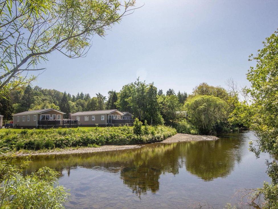 A view of caravans next to a river at Hornshole Hideaway Caravan Hawick Riverside Caravan Park near Hawick