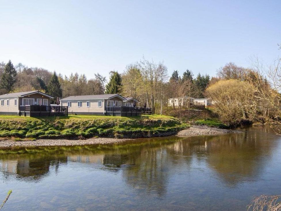 A view of caravans by a river at Hornshole Hideaway Caravan Hawick Riverside Caravan Park near Hawick