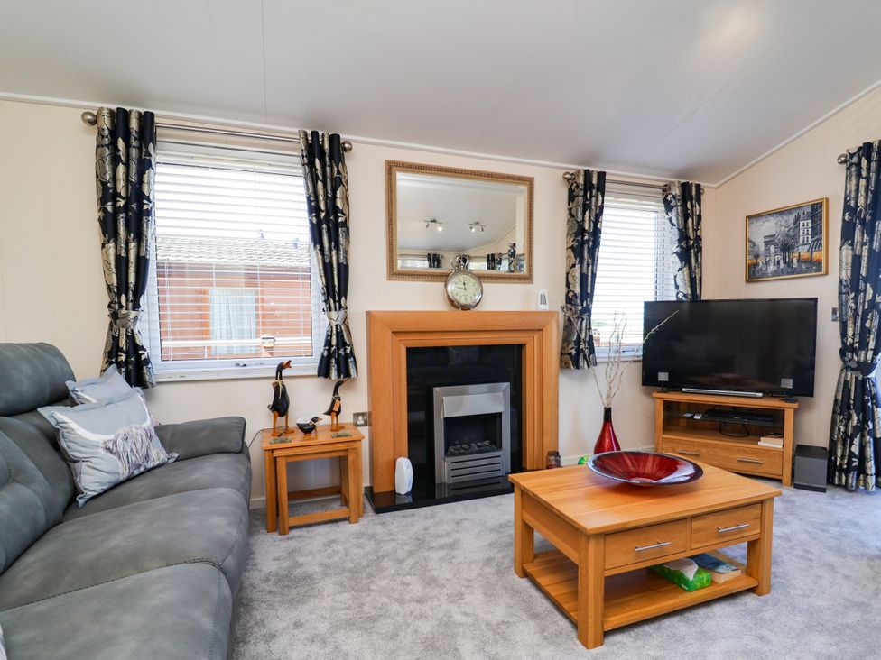 A living room with a sofa and coffee table at Banksy in Mullacott Park near Ilfracombe