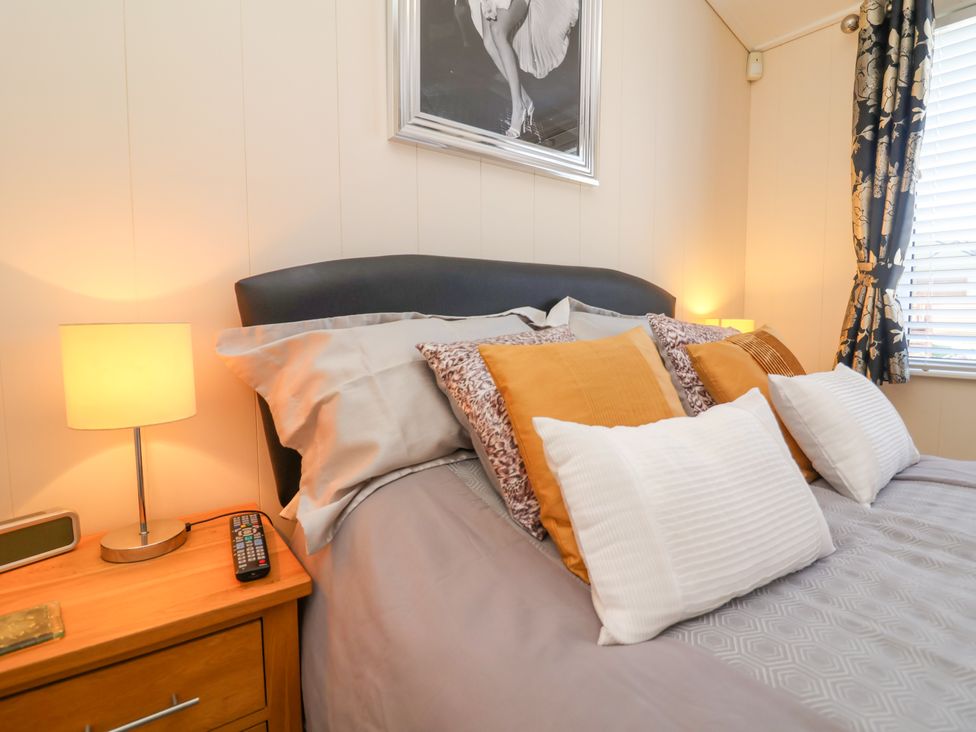 A bedroom with a bed and bedside table at Banksy in Mullacott Park near Ilfracombe