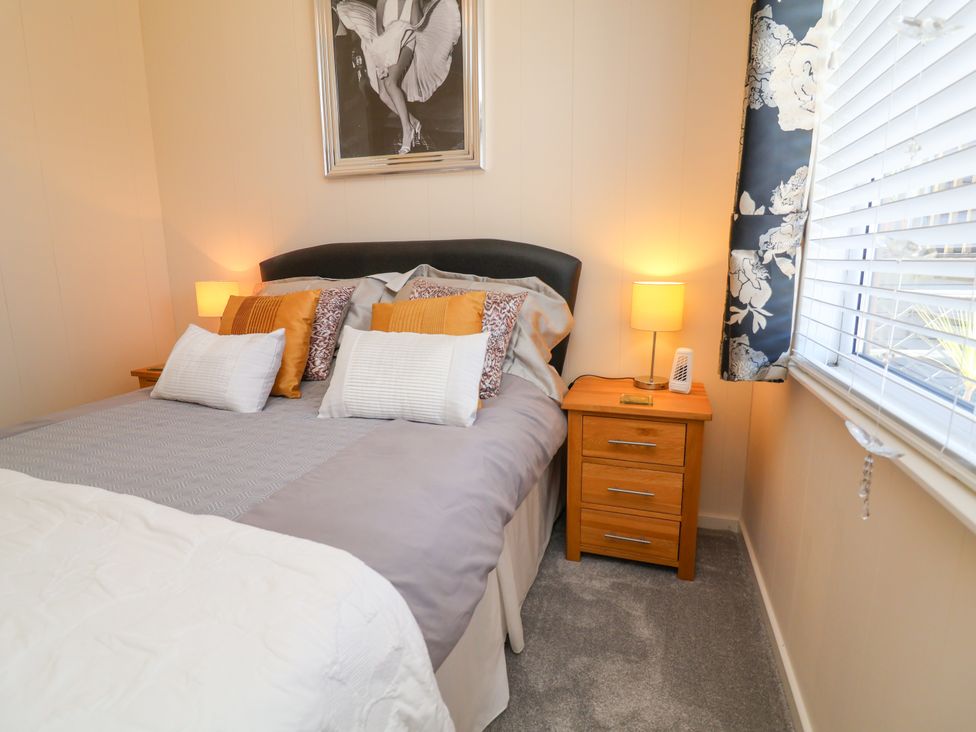 A bedroom with a bed and bedside table at Banksy near Mullacott Park in Ilfracombe