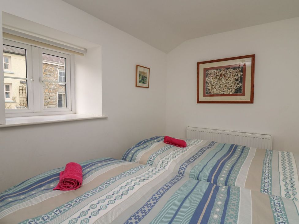 A bedroom with two beds and a window at Tegfan in Newport