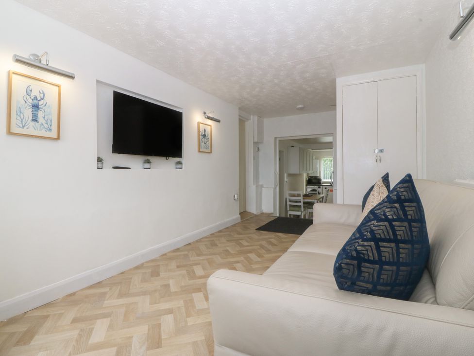 A living room with a sofa and television at Porth Ewyn House Trearddur Bay