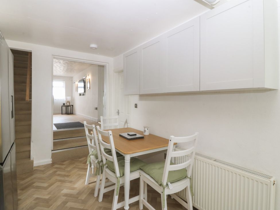 A dining area with a table and chairs at Porth Ewyn House Trearddur Bay
