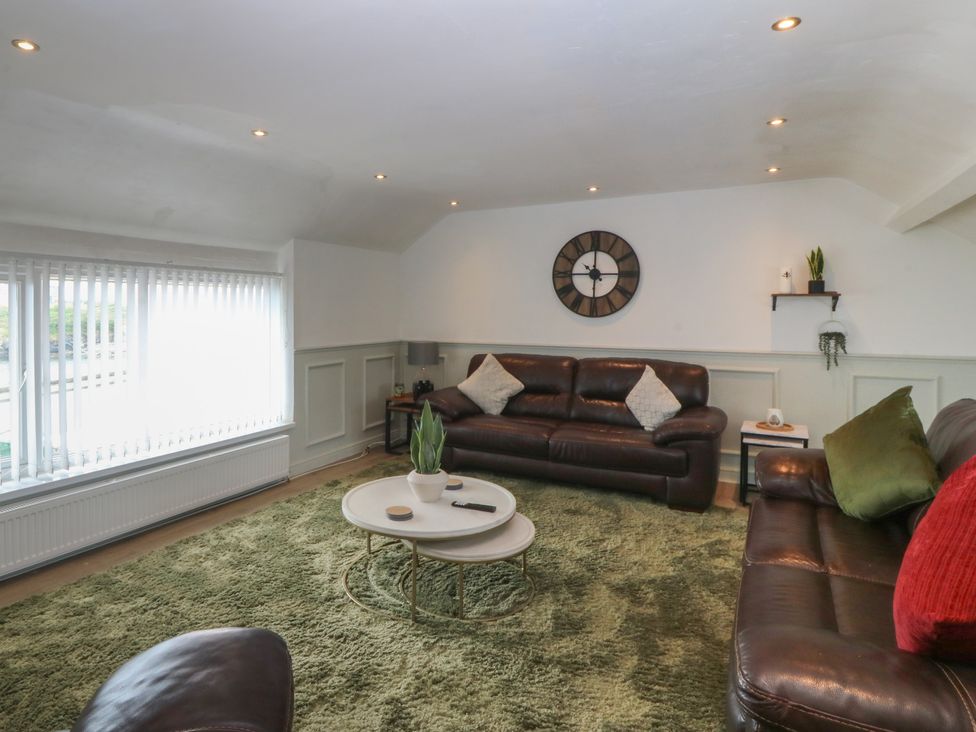 A living room with a sofa and coffee table at Porth Ewyn House Trearddur Bay
