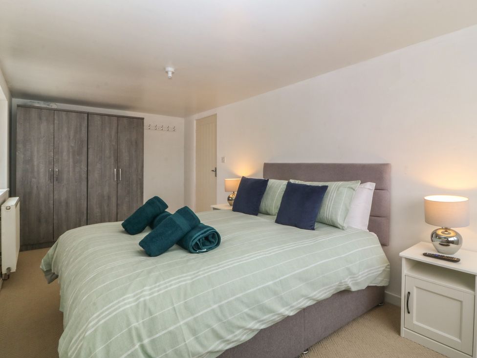 A bedroom with bed and wardrobe at Porth Ewyn House Trearddur Bay