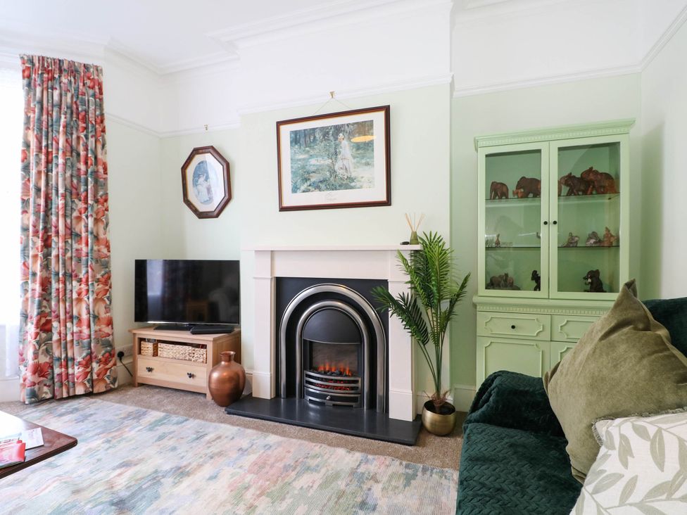 A living room with a fireplace and television at Fernleigh Margate